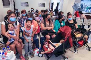 Group of young strabismus patients and their guardians (right) from Mariveles, Bataan wait for a check-up at the Tzu Chi Eye Center on 24 January.