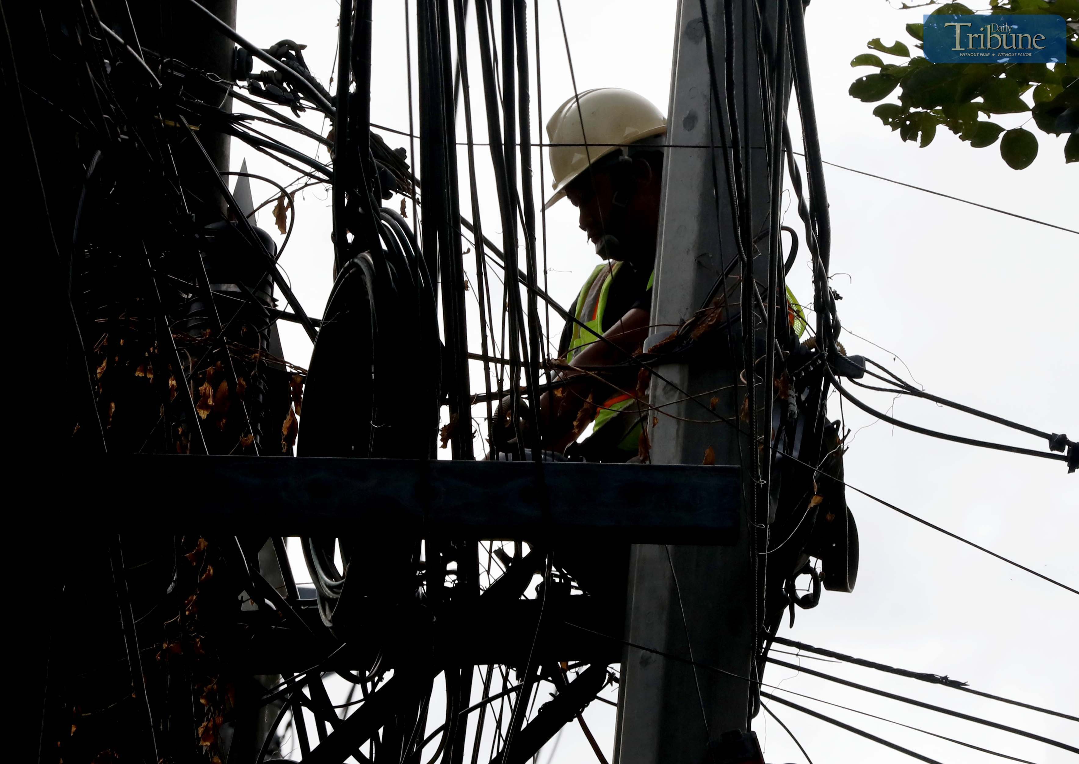 Meralco contractor repairs wires amid power interruptions in Metro Manila, Calabarzon
