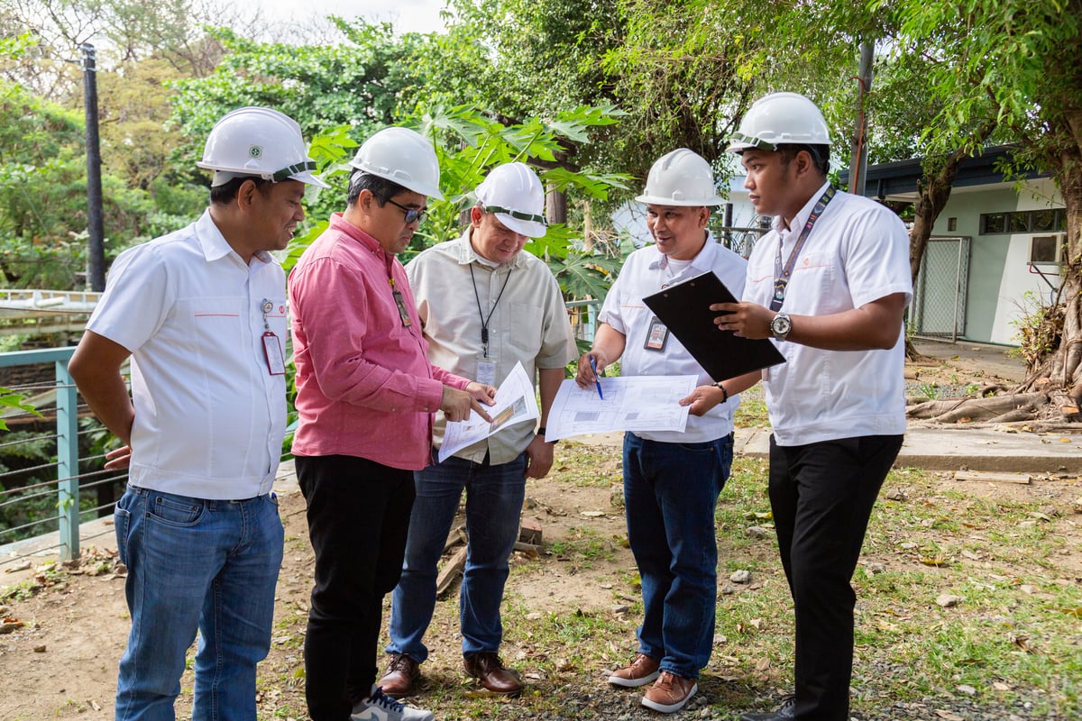 Head of Facilities and Safety Management, Jerry B. Lao, alongside his team, planning the catio — a safe haven for Meralco’s community cats.