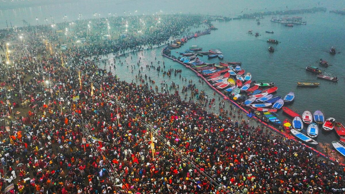 Hindu pilgrims taking a holy dip in the sacred waters of Sangam, the confluence of the Ganges, Yamuna and mythical Saraswati rivers, during the Maha Kumbh Mela festival in Prayagraj, Uttar Pradesh, India, on 13 January.
