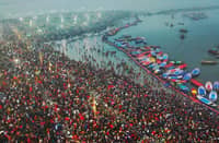 Hindu pilgrims taking a holy dip in the sacred waters of Sangam, the confluence of the Ganges, Yamuna and mythical Saraswati rivers, during the Maha Kumbh Mela festival in Prayagraj, Uttar Pradesh, India, on 13 January.