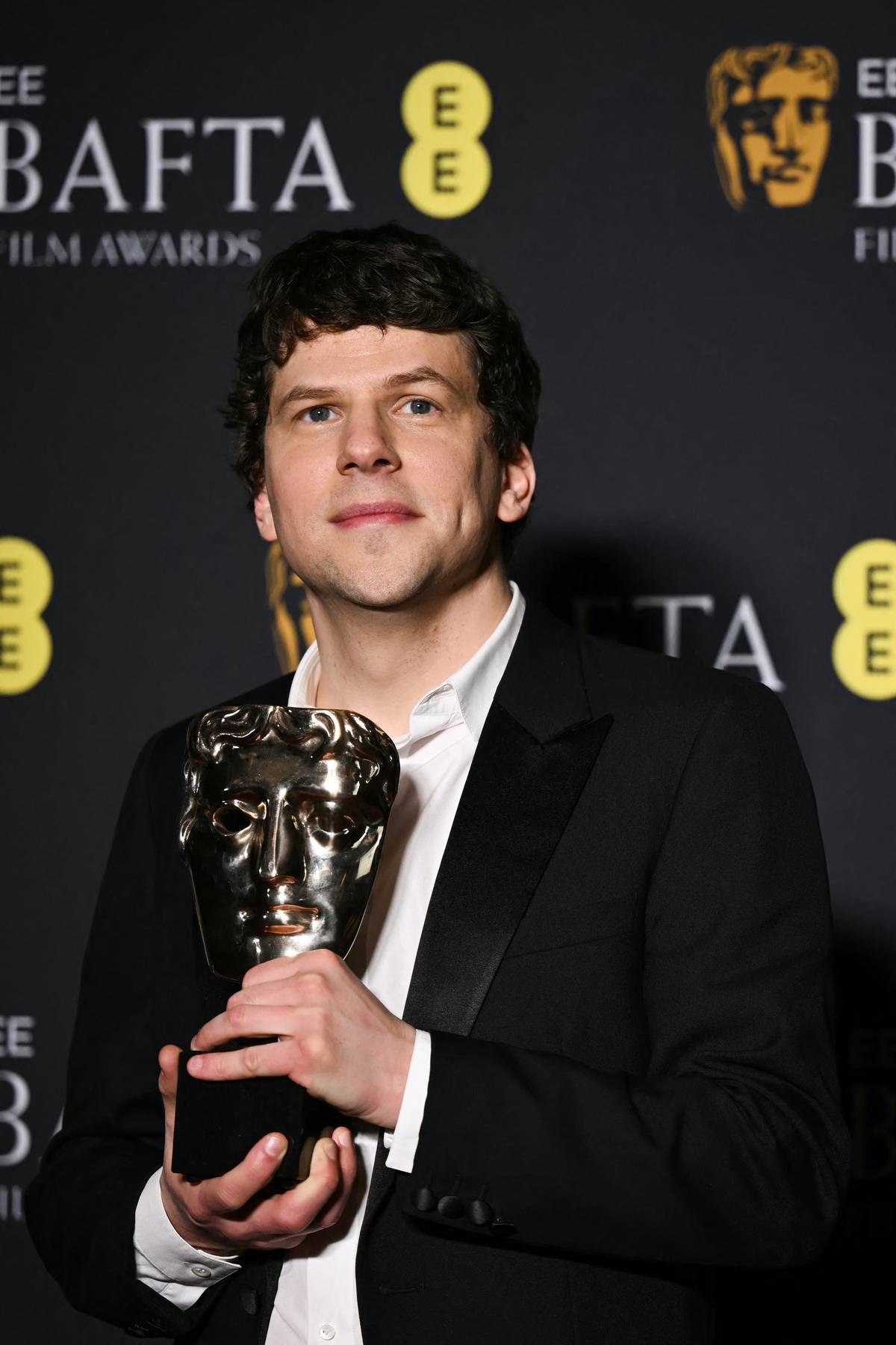 JESSE Eisenberg accepts the Best Supporting Actor award for Kieran Culkin.