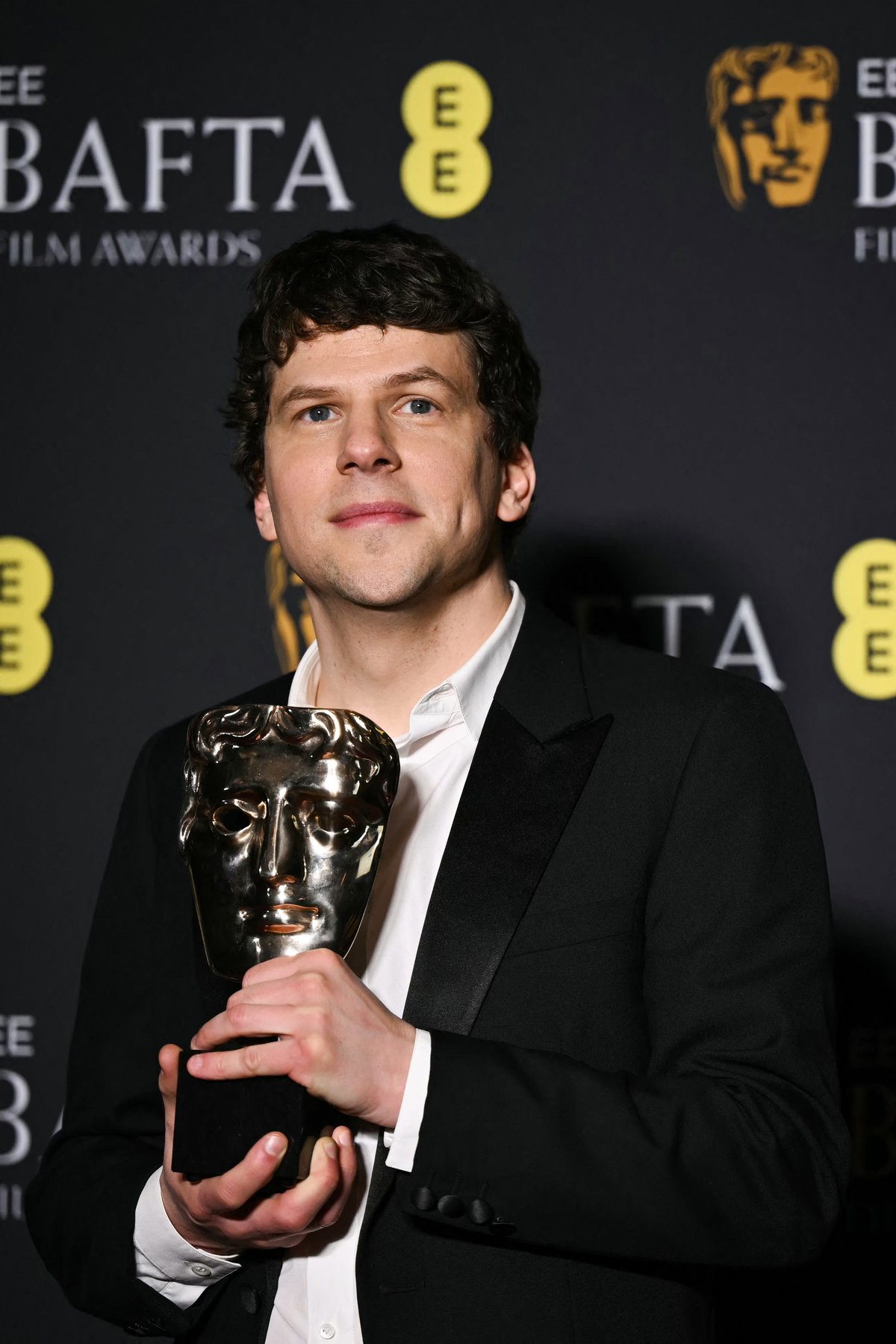JESSE Eisenberg accepts the Best Supporting Actor award for Kieran Culkin.