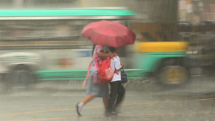 (FILES) Pedestrians in EDSA use umbrellas amidst heavy rains on 17 February 2025