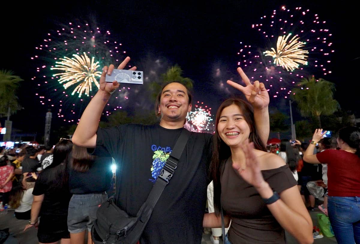 A couple shares a magical moment under the incredible pyrotechnic display.