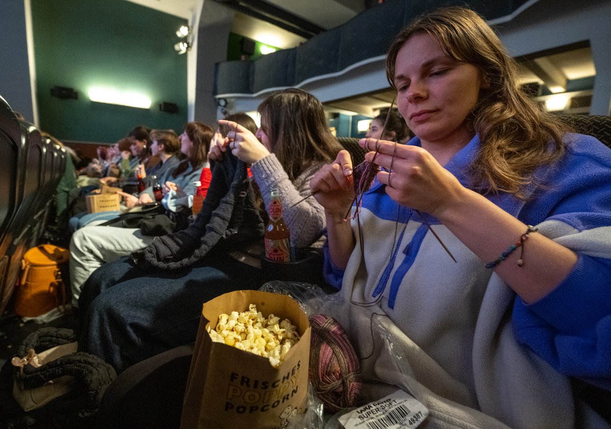 Women knits during the projection of the movie 'The Devil Wears Prada' at the Votive Cinema in Vienna, Austria, on 16 February 2025. Equipped with yarn and needles, dozens of dexterous moviegoers flock to a Viennese cinema every month to combine their favourite hobbies: knits and flicks.