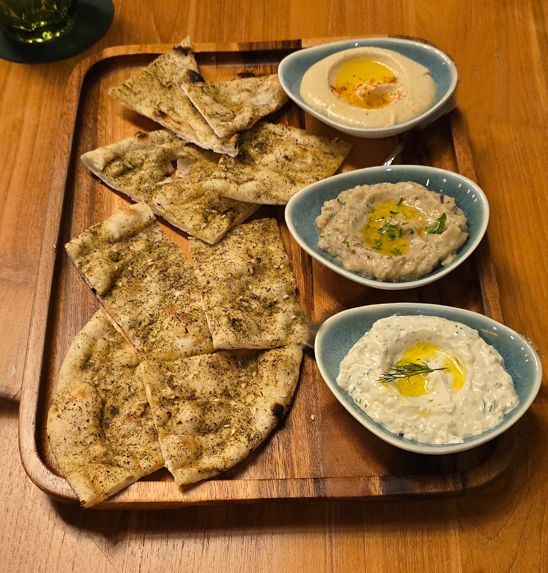 Dip Platter. A trio of hummus, babaganoush and tzatziki served with Afghaani naan.