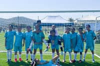 Members of the Bella Football Academy celebrate after lifting the CMC Youth Football International Tournament trophy in Thailand over the weekend.