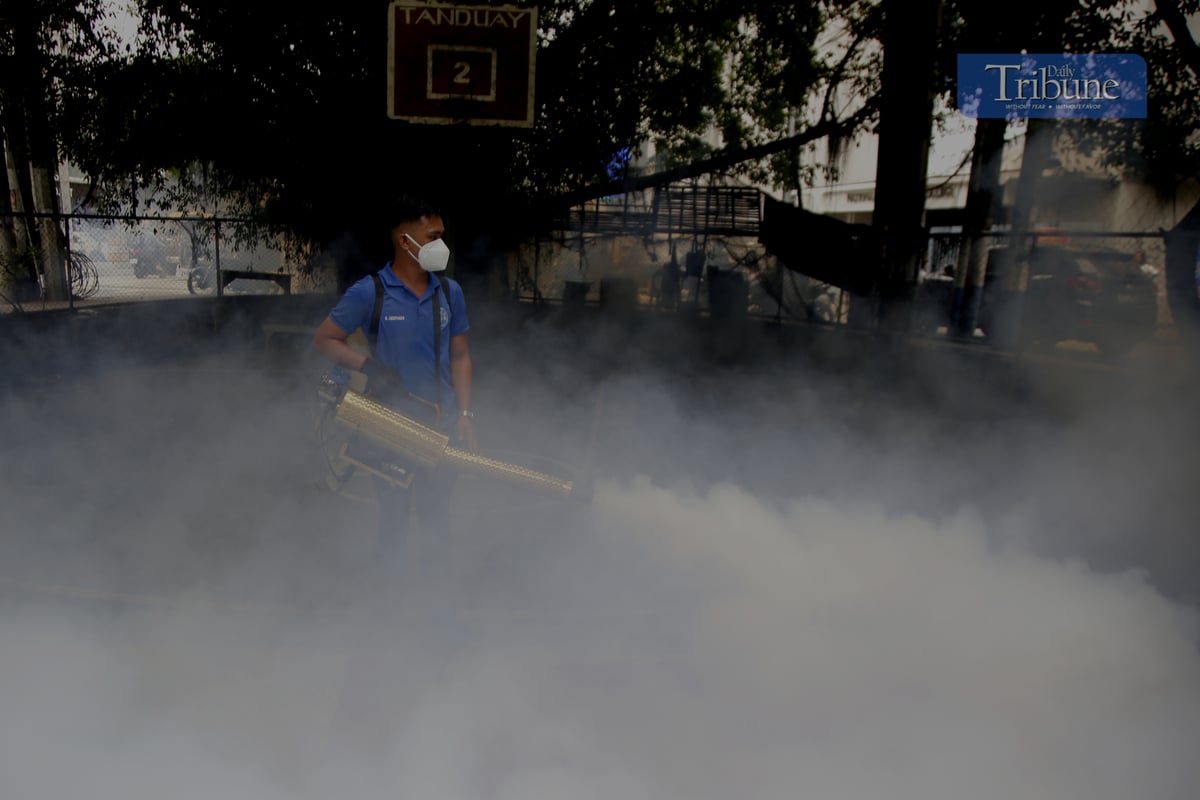 Manila City's Disaster Risk Reduction Office conducts fogging operations in Barangay 390 on 20 February 2025 as dengue cases rise, with Quezon City declaring an outbreak.