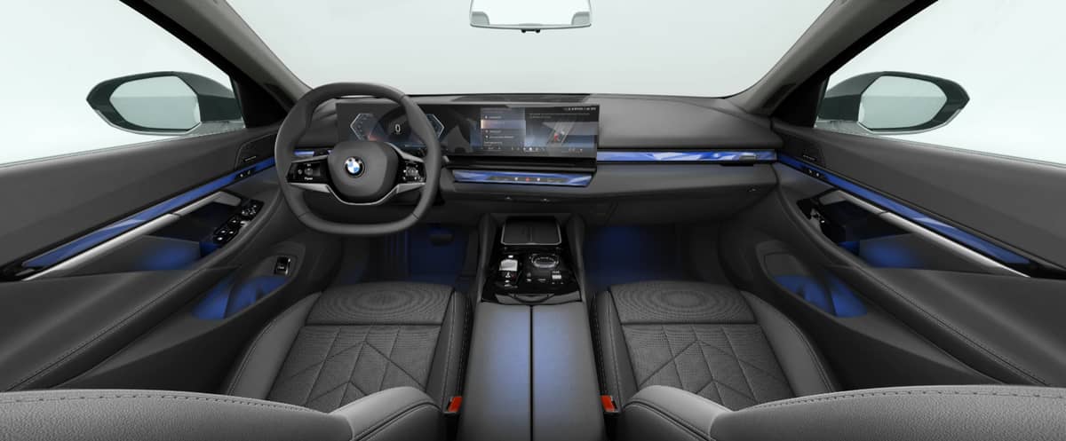 The BMW 520i’s interior combines Veganza Perforated & Quilted upholstery, four-zone climate control, and a wide iDrive display for a refined driving experience.
