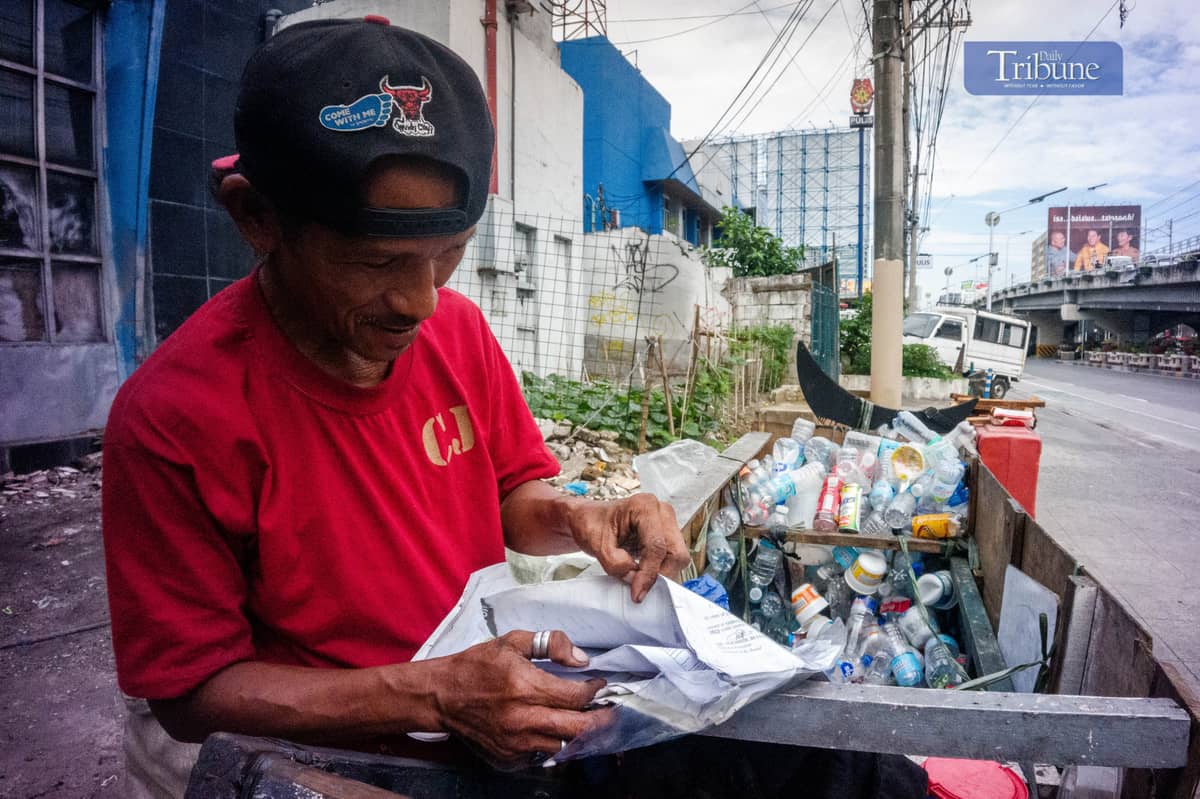 Rolando shows his vaccine documents.