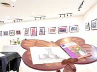 The exhibit is interactive as it invites visitors to sketch or draw the still life objects on display in the exhibit.