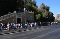 People walk in the middle of Alameda Avenue during a blackout in Santiago on 25 February 2025. In the middle of the austral summer season, Chile is facing this Tuesday an unusual and massive blackout due to an alleged failure of the power system, which forced the evacuation of the Santiago subway and plunged the population into confusion.