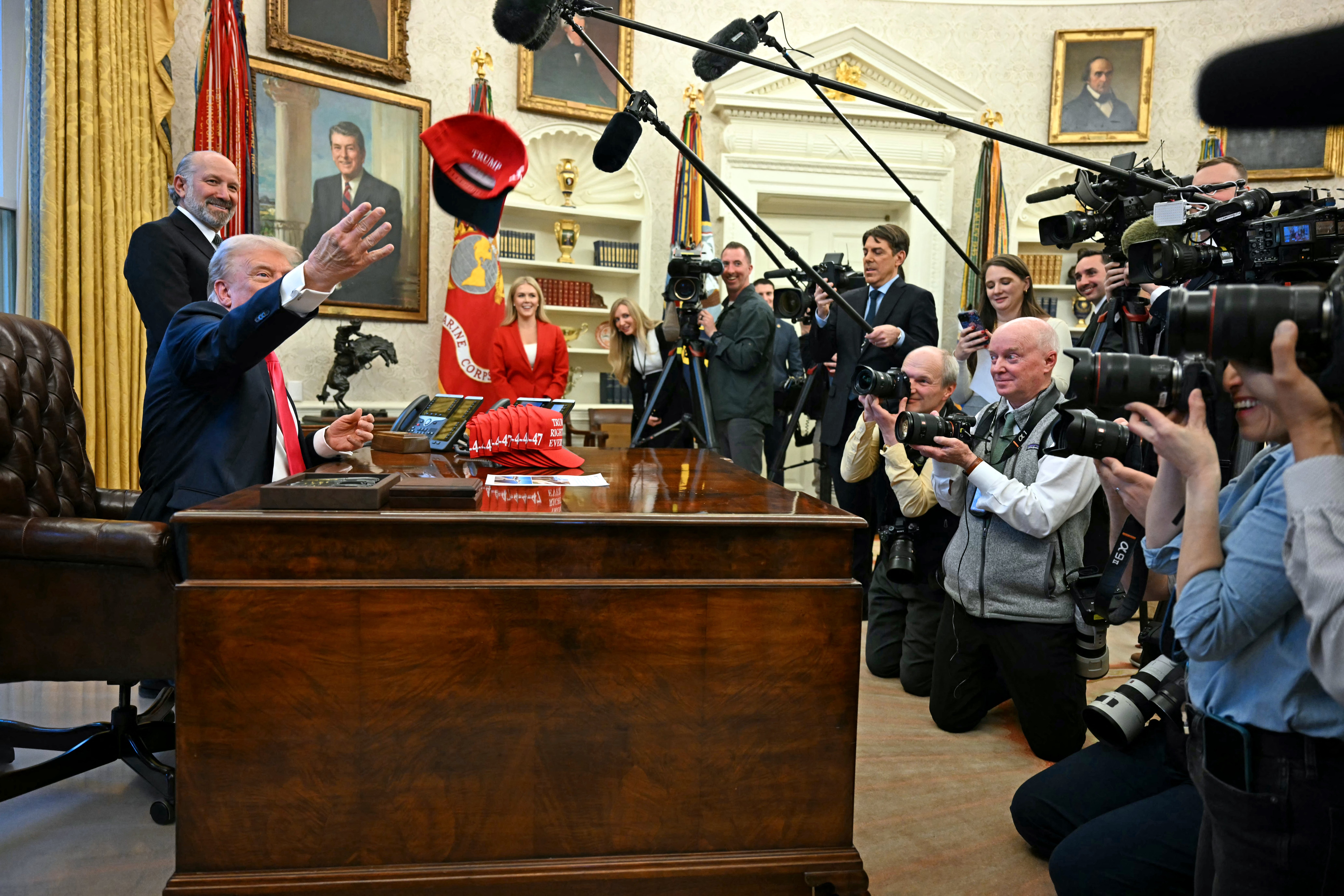 US President Donald Trump throws a hat reading ‘Trump was right about everything’ after signing an Executive Order at the Oval Office of the White House in Washington, DC on 25 February 2025.