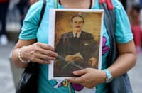 A woman holds a portrait of Venezuelan doctor Jose Gregorio Hernandez at La Candelaria Church in Caracas on 25 February 2025. Pope Francis, hospitalized in 'critical' condition, authorized the canonization of the "doctor of the poor" Jose Gregorio Hernandez, who will become Venezuela's first saint, the Venezuelan Catholic Church said on 25 February 2025.