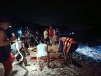 Rescuers put inside a body bag the bodies of two Russians who perished in a scuba diving venture in Verde Island, Batangas on Thursday.