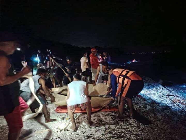 Rescuers put inside a body bag the bodies of two Russians who perished in a scuba diving venture in Verde Island, Batangas on Thursday.