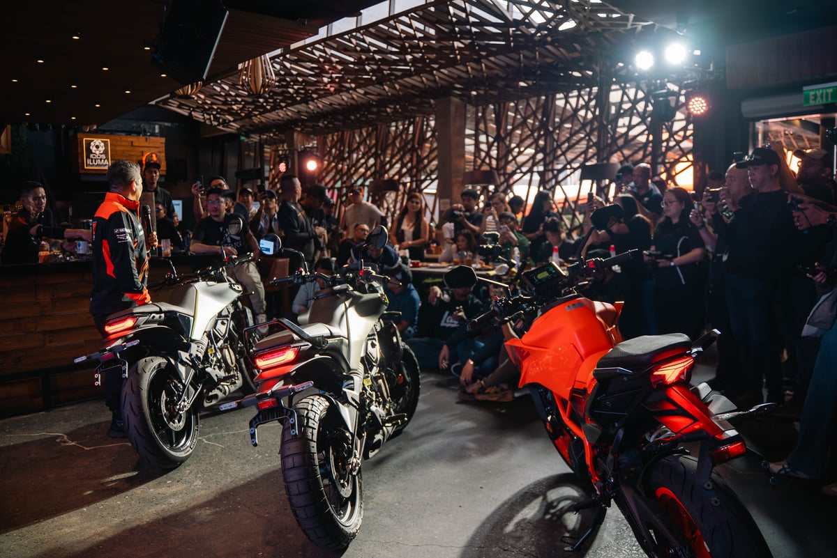 A captivated crowd gathers as the latest KTM and Husqvarna motorcycles make their grand debut.