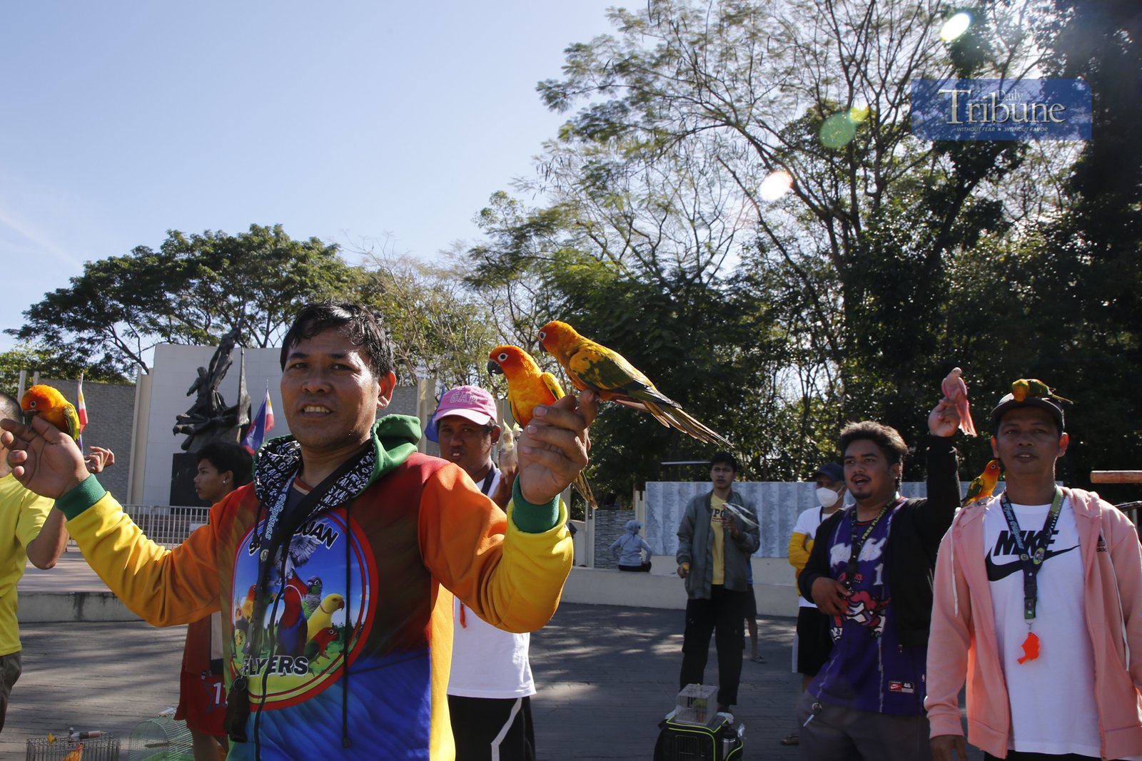 Bird keepers gather at the Pinaglabanan Memorial Shrine in San Juan City on Sunday, 2 March 2025, to train their colorful pets, including parrots, pigeons, and cockatiels. The trees around the shrine have become a perfect resting spot for these feathered friends.