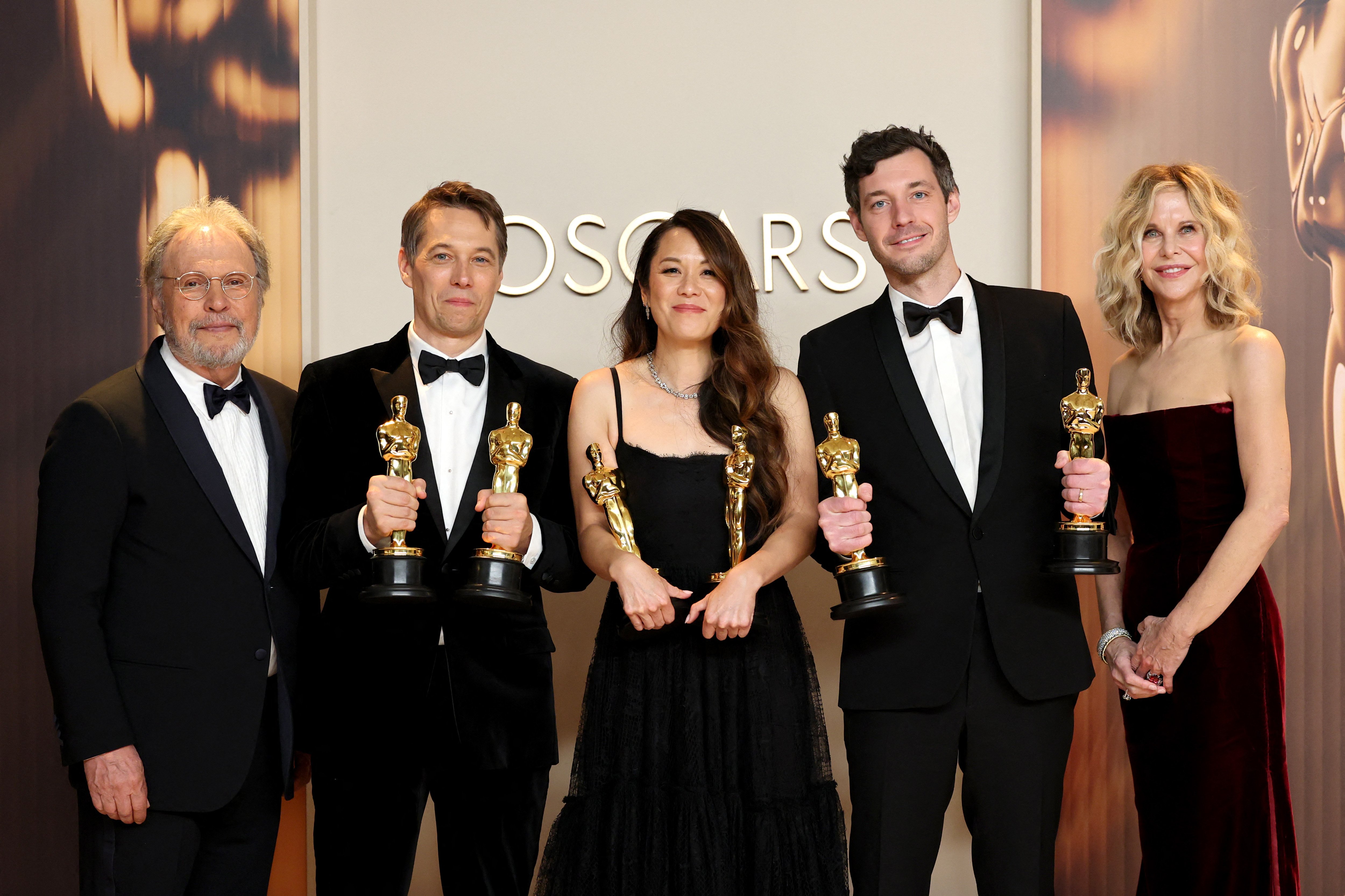 (L-R): Sean Baker, Samantha Quan, and Alex Coco, winners of the Best Picture for “Anora”, pose in the press room with Billy Crystal and Meg Ryan during the 97th Annual Oscars at Ovation Hollywood on March 02, 2025 in Hollywood, California