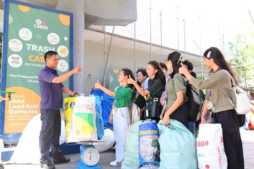Students, who brought in their trash, receive cash incentives from SM personnel for their commitment to a sustainable future.