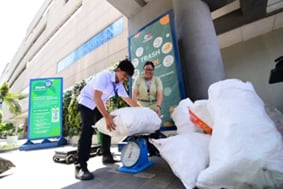 A STUDENT weighs recyclables with his teacher at SM Cares' 'Trash to Cash,' proving that every small effort adds up to a greener future.