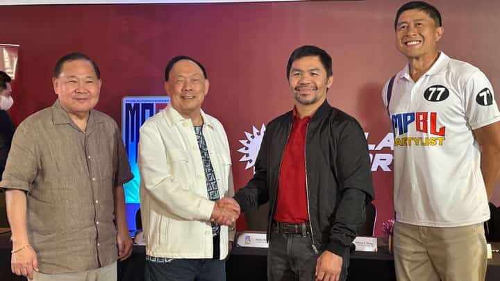 MPBL founder and CEO Manny Pacquiao and Solar Entertainment Corporation CEO and president Wilson Tieng shake hands after signing a broadcast agreement. Also shown are MPBL commissioner Kenneth Duremdes and Solar Sports chairman William Tieng.
