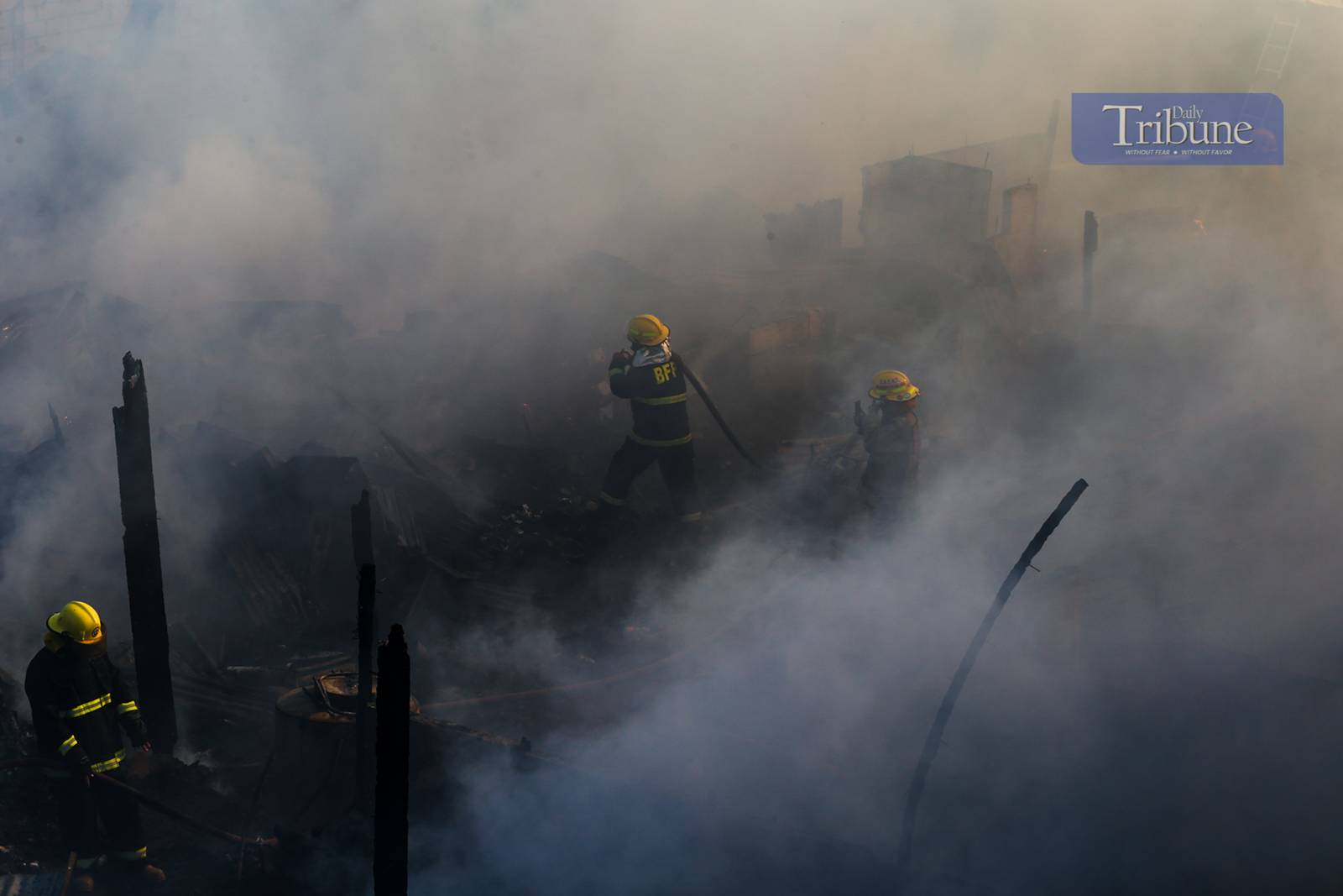 Residents and firefighters extinguish a fire that hit a residential community in Barangay Ususan, Taguig City, on the 4th day of Fire Prevention Month, 4 March 2025. The fire, which prompted the raising of the 4th alarm at 2:45 PM, was declared under control at 3:27 PM.