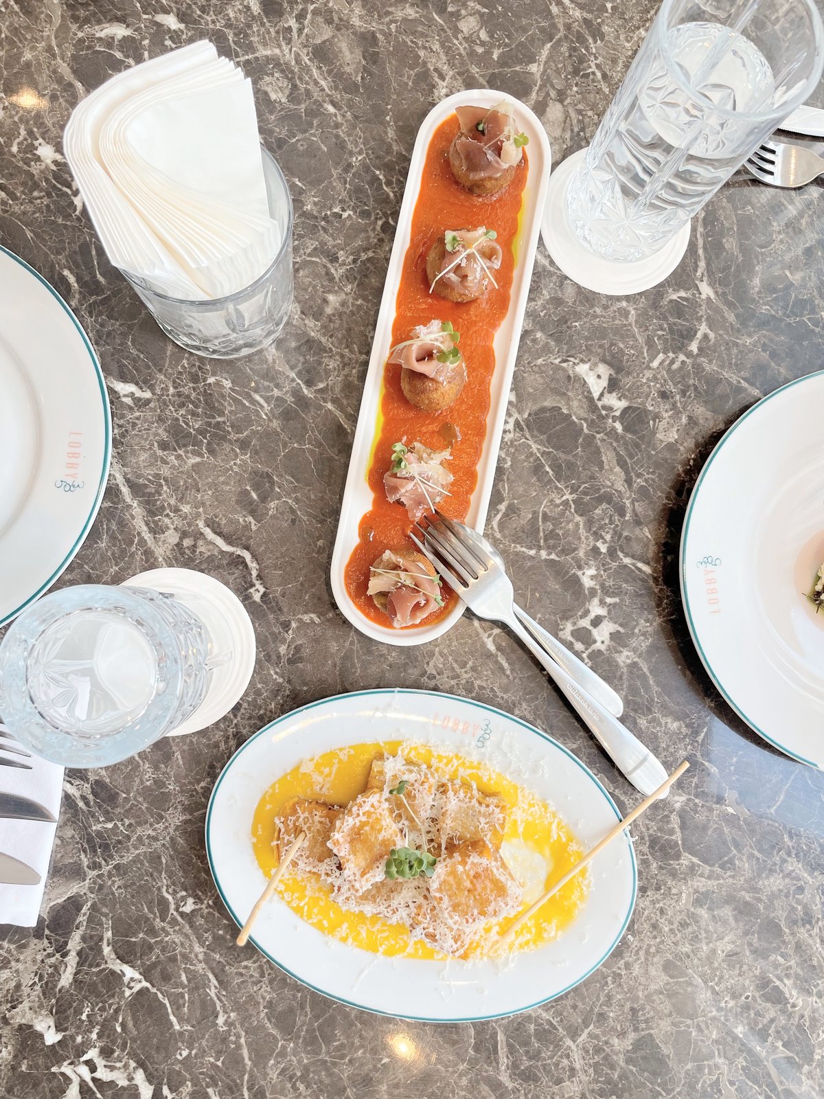 Bacalao Croquettes topped with Prosciutto and Potato Pave Crisp.