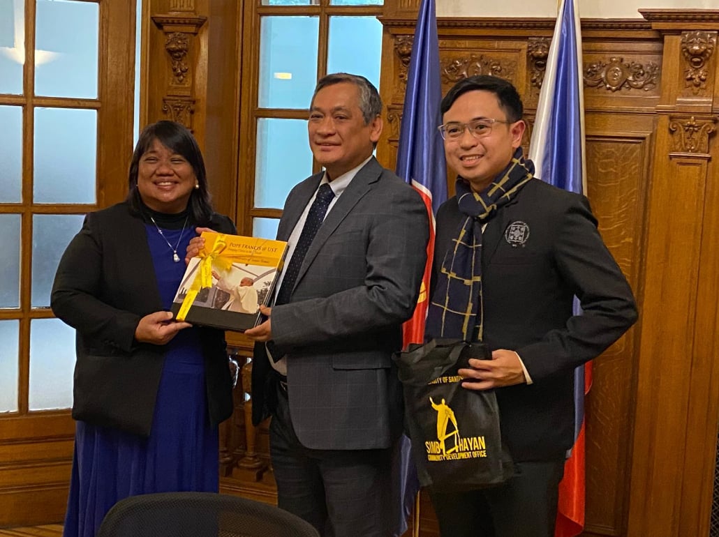 The Ambassador of the Philippines to Belgium His Excellency Jaime Victor B. Ledda (center) receives a token from the University presented by UST CRS Assistant Dean Assoc. Prof. Georgina Mojica (left) and CRS academic staff and UST SIMBAHAYAN Community Development Office Assistant Director Asst. Prof. Christian Rey Rimando.