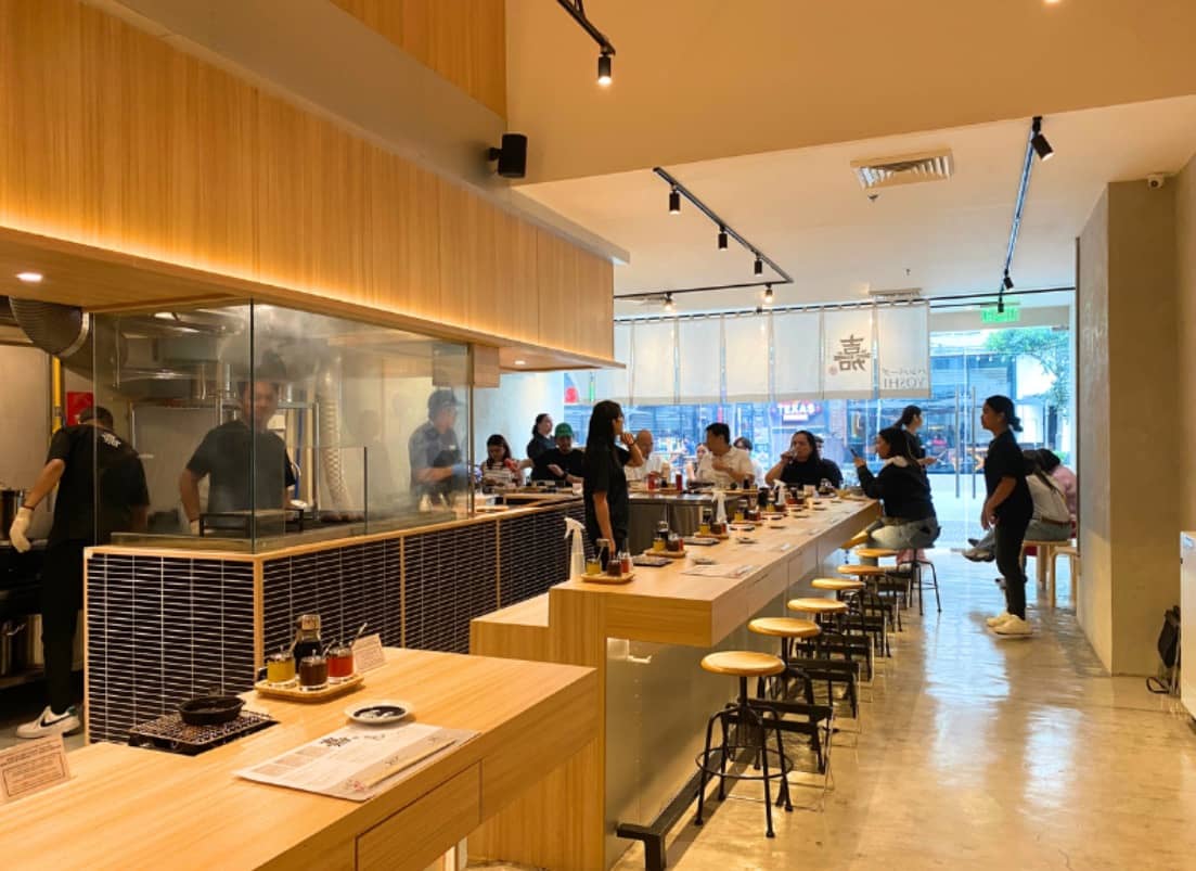 Hamburg Yoshi contemporary wood-themed interiors creates a cozy and inviting atmosphere for diners.