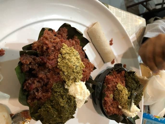 Kitfo or raw beef, minced and served with spice sauce and yogurt.