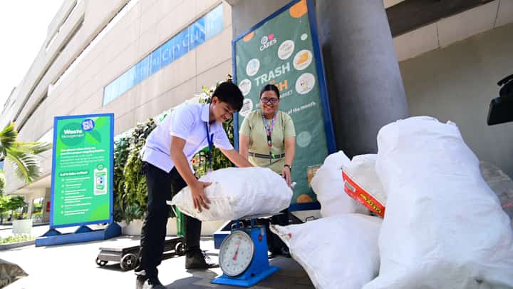Student weighs recyclables with his teacher at SM Cares’ ‘Trash to Cash,’ proving that every small effort adds up to a greener future.
