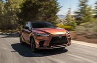 LEXUS RX cruising smoothly under the warm summer sun.