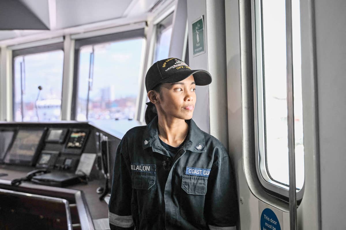 Stephane Villalon, a Philippine Coast Guard radio operator working with the all-women ‘Angels of the Sea’ program, posing for a photo on a ship in Manila.