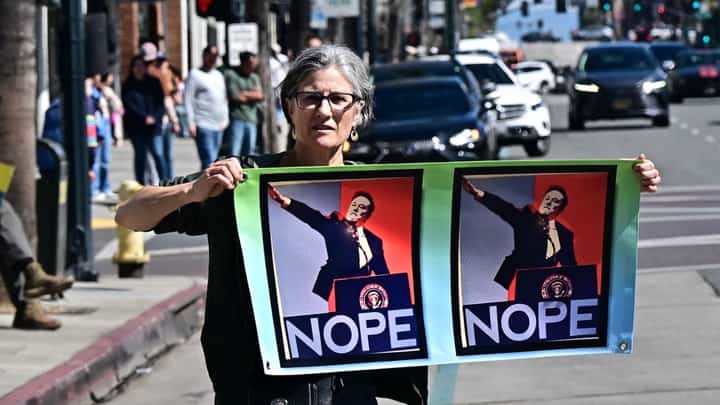 People participate in a "Tesla Takedown" protest against Elon Musk outside a Tesla dealership in Pasadena, California, 8 March 2025. US President Donald Trump's senior advisor Elon Musk is leading the so-called Department of Government Efficiency (DOGE), which has cut thousands of government jobs and upended agencies, prompting numerous court challenges.