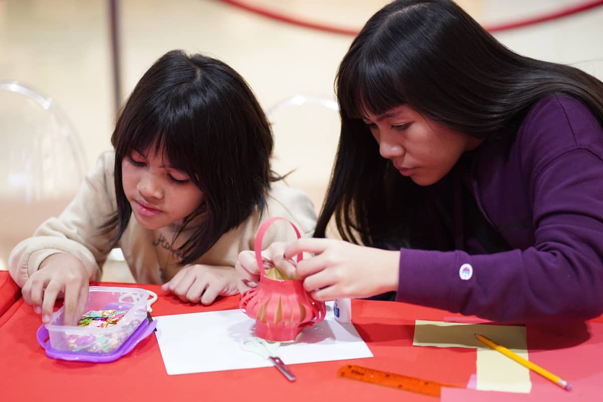 Attendees create their first handmade lantern, celebrating cultural traditions through craft and storytelling.