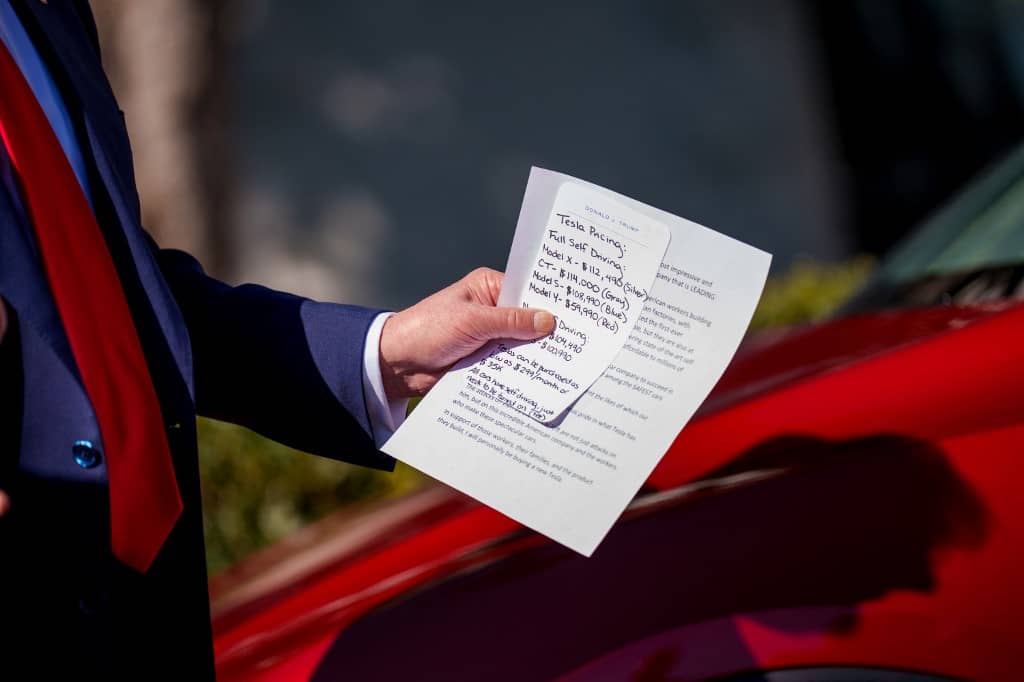 (EDITOR'S NOTE: Alternate Crop) U.S. President Donald Trump holds notes on the pricing of Tesla vehicles as he delivers remarks on the South Lawn of the White House on March 11, 2025 in Washington, DC. Trump spoke out against calls for a boycott of Elon Musk's companies and said he would purchase a Tesla vehicle in what he calls a 'show of confidence and support' for Elon Musk.