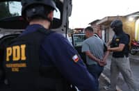 This handout picture released by Investigations Police of Chile shows a police operation carried out to dismantle a cell of the Venezuelan criminal gang 'Tren de Aragua' and which also identified another group of alleged people who also participated in the crime of former Venezuelan military dissident Ronald Ojeda in Santiago on 22 January 2025. Chilean prosecutors said Thursday that a key witness in the investigation into the murder in this country of former Venezuelan military dissident Ronald Ojeda accused Diosdado Cabello, interior minister of the government of Nicolás Maduro, of being responsible for his death.