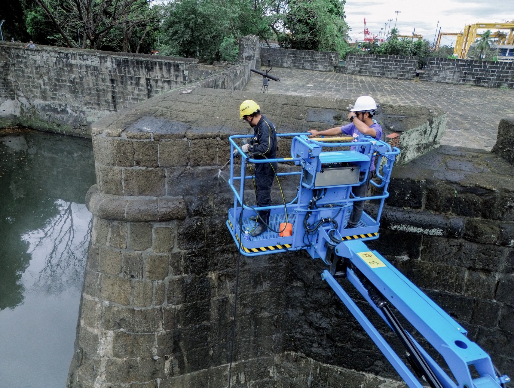 Using a crane to reach upper section.