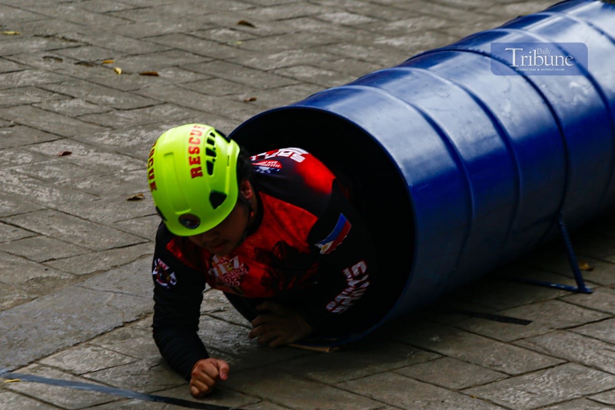 Fire volunteers from various barangays in San Juan City compete in obstacle courses simulating fire emergencies during the annual Fire Olympics on 17 March 2025.