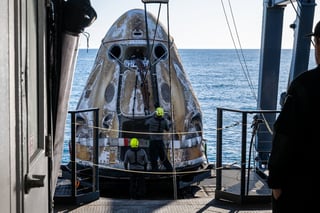 Astronauts touch down as politics swirl