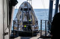 This photo provided by NASA shows support teams onboard the SpaceX recovery ship MEGAN working around a SpaceX Dragon spacecraft shortly after it landed with NASA astronauts Nick Hague, Suni Williams, Butch Wilmore, and Roscosmos cosmonaut Aleksandr Gorbunov aboard in the water off the coast of Tallahassee, Florida, 18 March 2025.