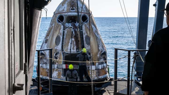 This photo provided by NASA shows support teams onboard the SpaceX recovery ship MEGAN working around a SpaceX Dragon spacecraft shortly after it landed with NASA astronauts Nick Hague, Suni Williams, Butch Wilmore, and Roscosmos cosmonaut Aleksandr Gorbunov aboard in the water off the coast of Tallahassee, Florida, 18 March 2025.