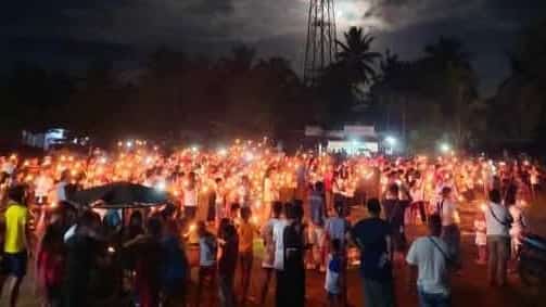 People gather in Las Nieves, Agusan del Norte on Saturday night, holding candles and praying for the return of FPRRD.