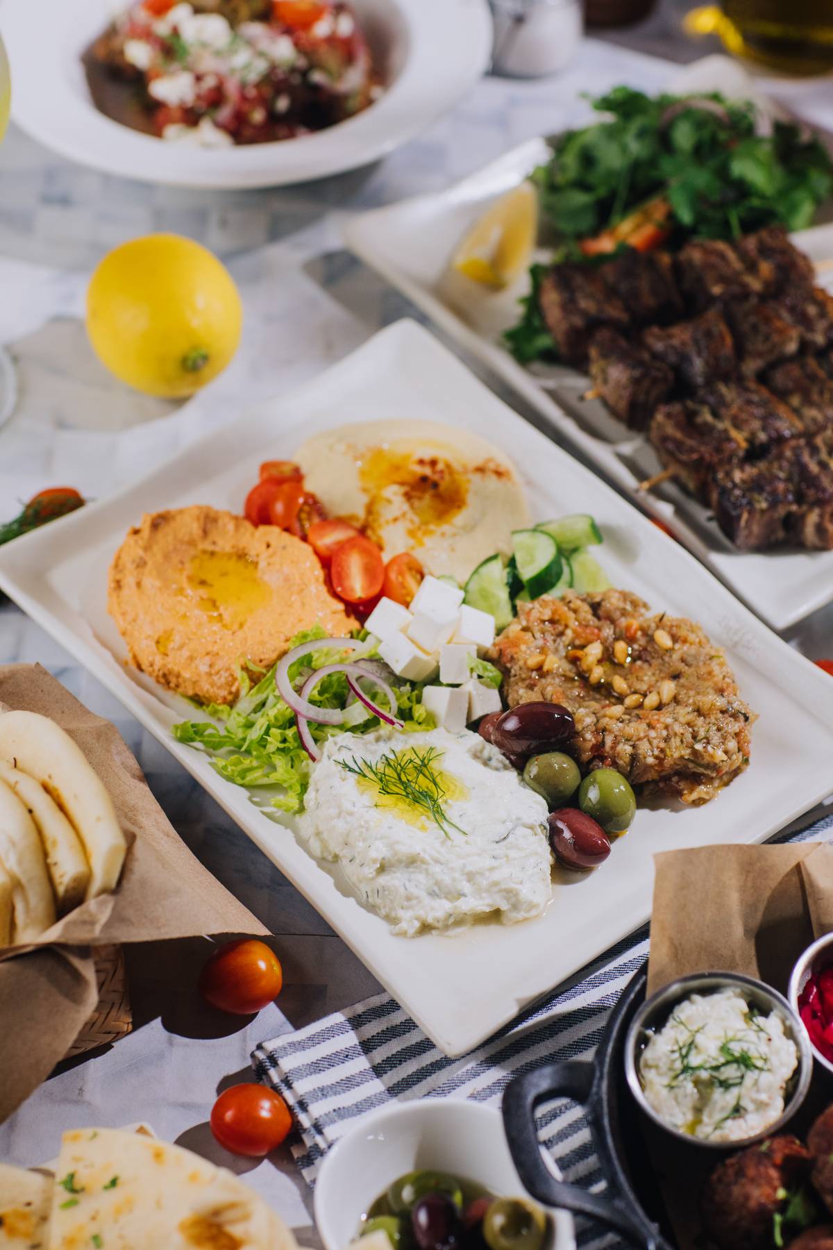 4 dip sampler Have a taste of Elaia’s mezze Tzatziki (Greek yogurt, cucumber, dill, garlic), Melitzanosalata (Roasted eggplant, pine nuts, feta), Hummus ( Chickpeas, tahini, EVOO) and Tirokafteri (Creamed feta, roasted peppers).