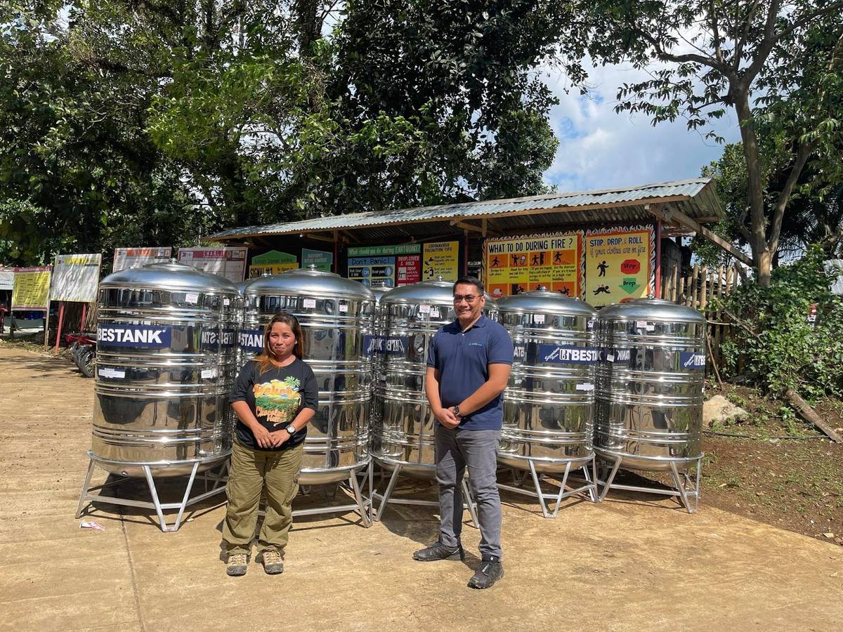 Impasugong Municipal Disaster Risk Reduction and Management Office head Joy Obsioma (left) receives water tanks from Hedcor, represented by external relations manager David Tacder (right). This effort is meant to help the local residents, especially during the dry season.