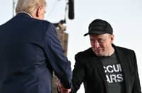 (FILES) Tesla CEO Elon Musk (R) joins former US President and Republican presidential candidate Donald Trump during a campaign rally at the site of his first assassination attempt in Butler, Pennsylvania on 5 October 2024. Donald Trump announced 12 November 2024 that the world's richest man, Elon Musk, will lead a new US government efficiency group tasked with cutting federal waste, as the Republican president-elect added a series of seasoned figures and hardliners to his incoming administration. Musk became a key ally to Trump during his campaign, reportedly spending over $100 million to help the Republican win and repeatedly boosting Trump's candidacy on X, the platform he owns.
