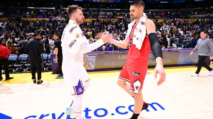 Luka Doncic #77 of the Los Angeles Lakers greets Nikola Vucevic #9 of the Chicago Bulls after the game on March 22, 2025 at Crypto.Com Arena in Los Angeles, California.