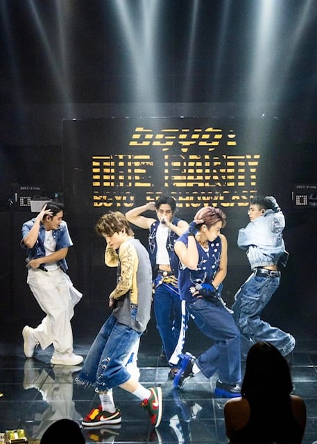 The all-male group performs for their fans.